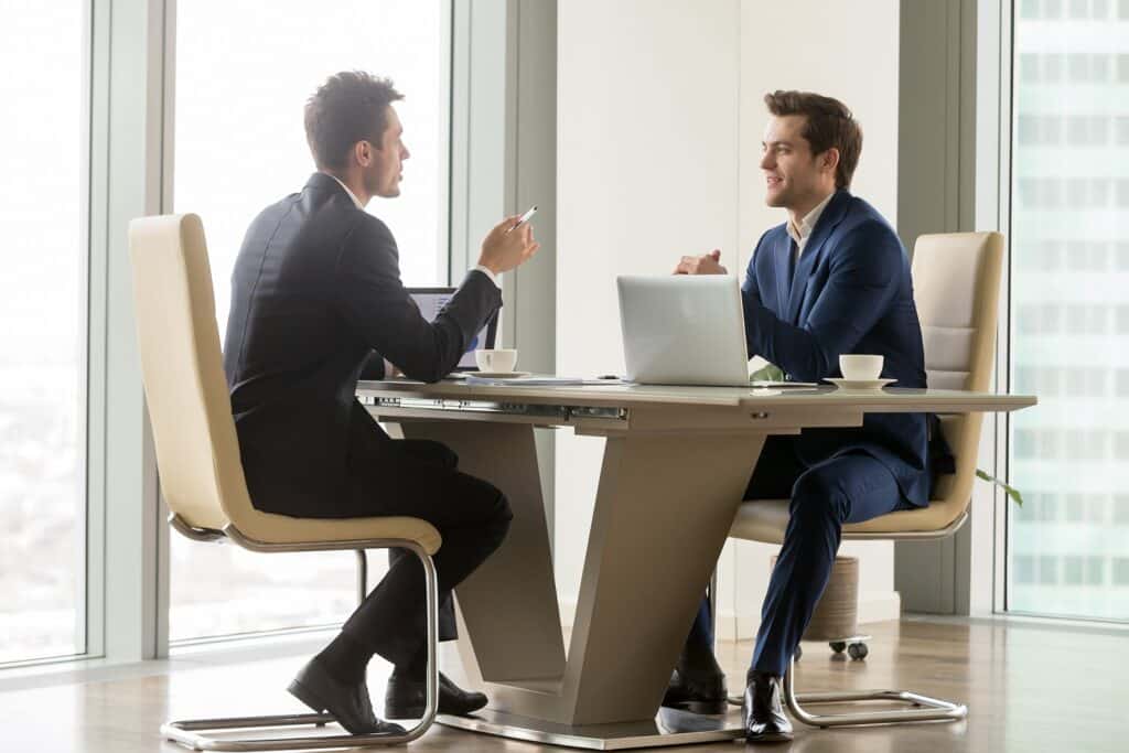 Two men hold a business meeting