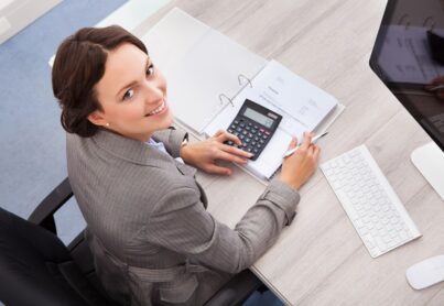 A female accountant works on a calculator