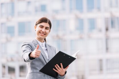 Businesswoman with clipboard outdoors