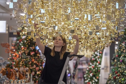 John Lewis staff member puts up Christmas decorations