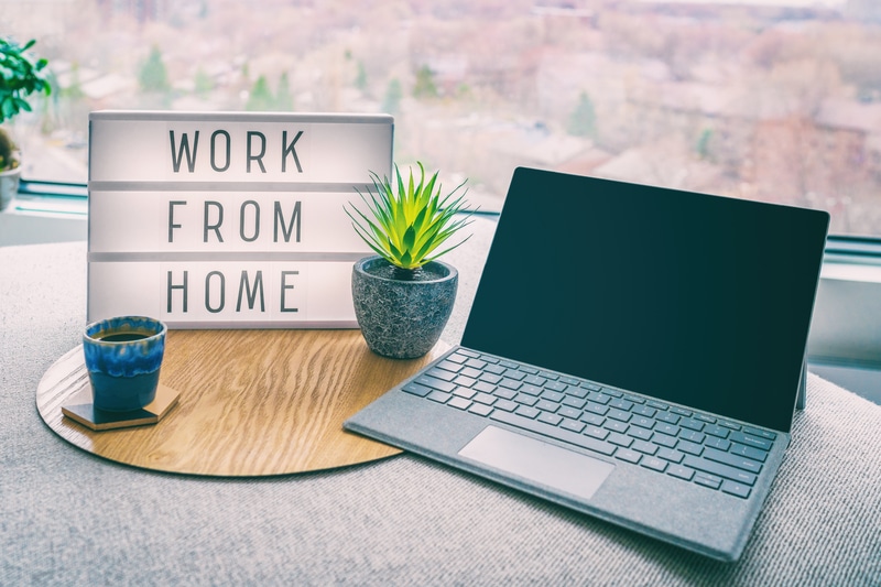 laptop with the words work from home next to it