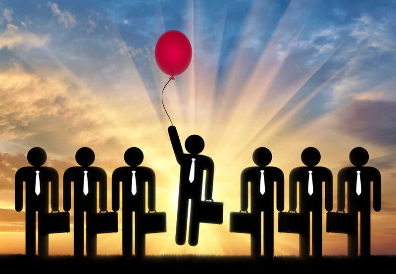 7 woekrs that all look the sane with 1 flying up with a balloon