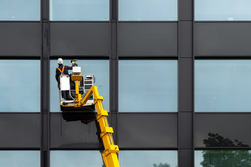 someone high up cleaning a window
