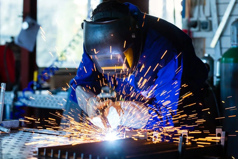 Man in a special uniform welding