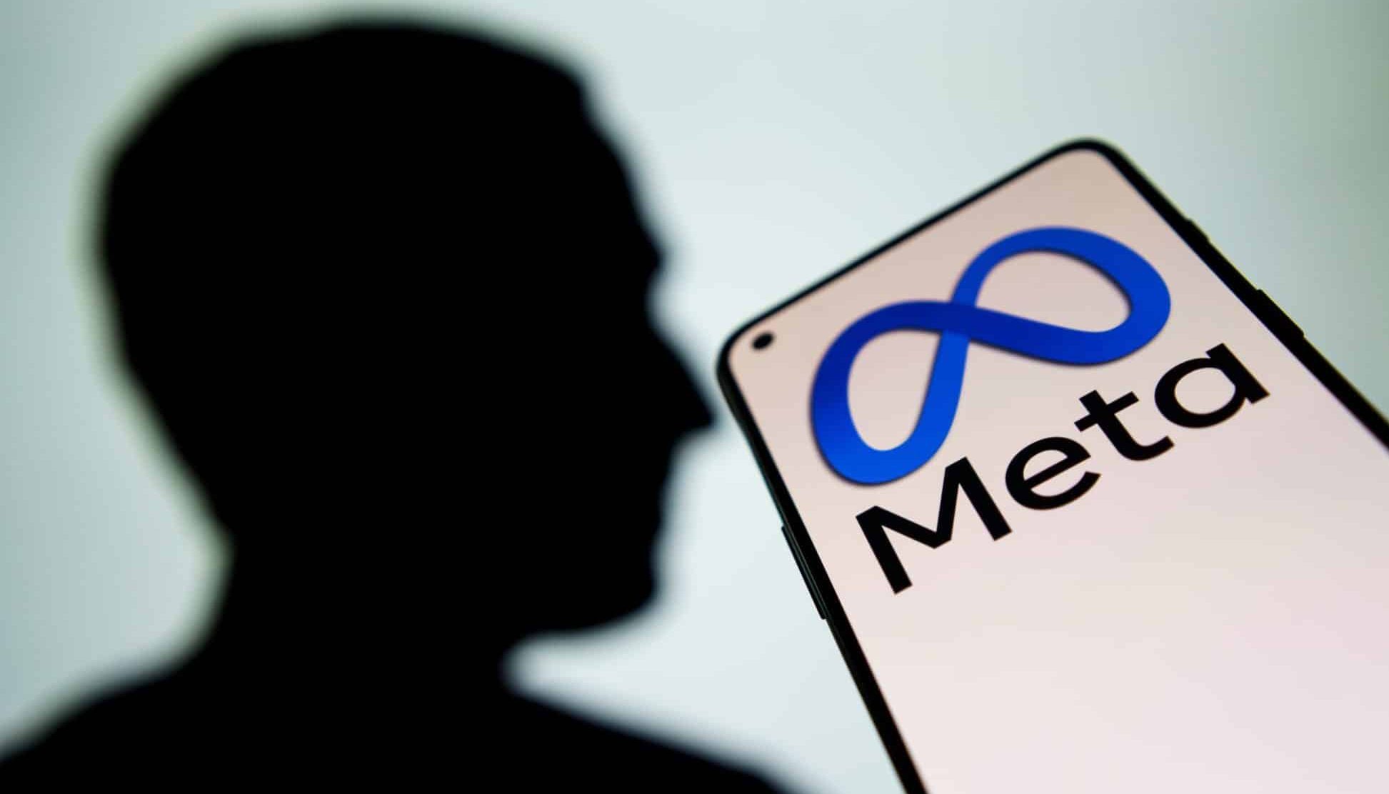 Meta logo and Mark Zuckerberg silhouette on screen