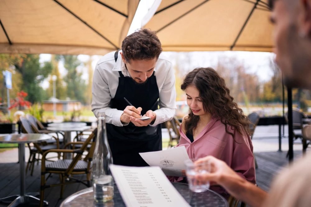 Waiting staff staking order from a customer