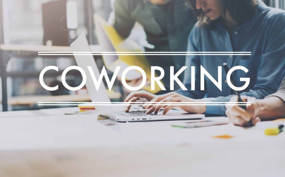 A coworking space with young professional typing on their laptop