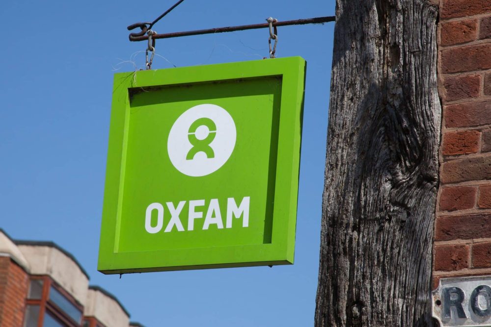 The Oxfam sign hanging from a charity shop in Warwickshire, UK