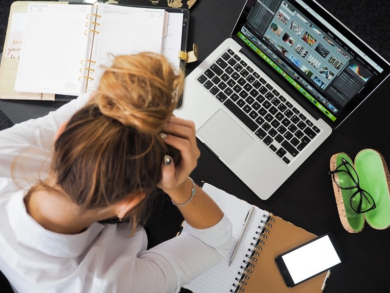 A worker studies at their laptop
