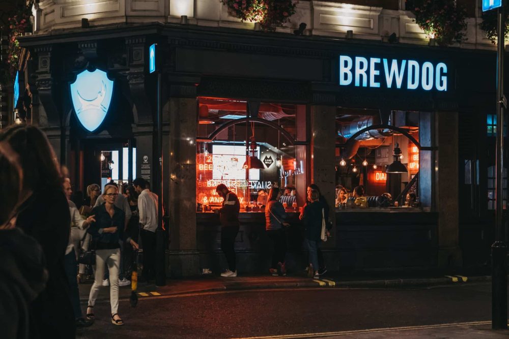 People standing outside Brewdog pub in Covent Garden, London, UK
