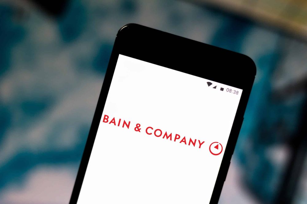 Bain & Company logo is displayed on a smartphone