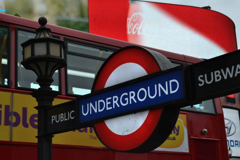 London underground sign and part of red double decker bus in the background
