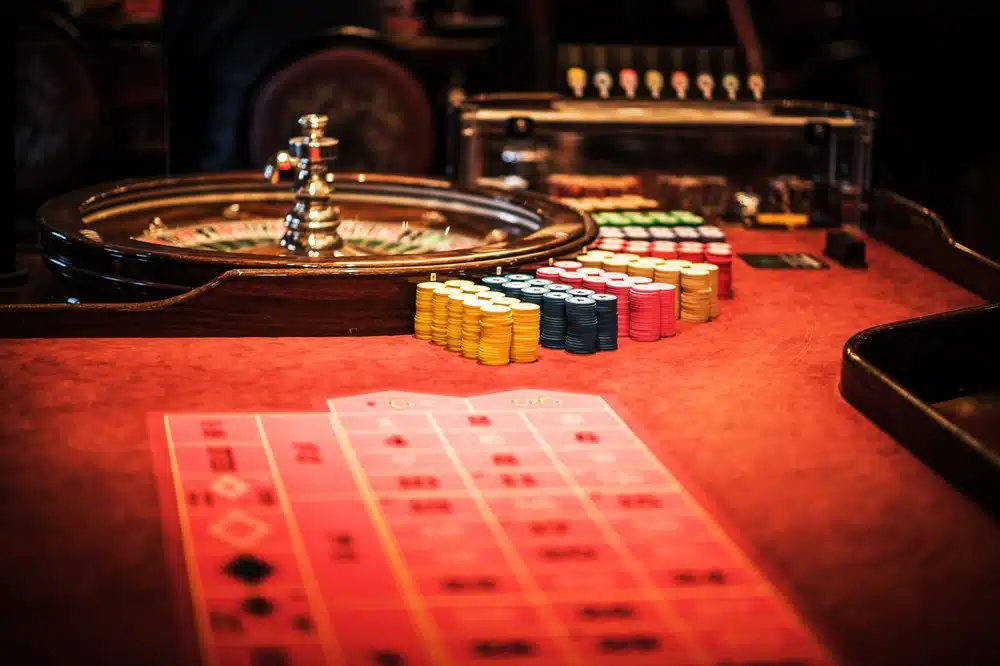 A casino with cards and a roulette wheel