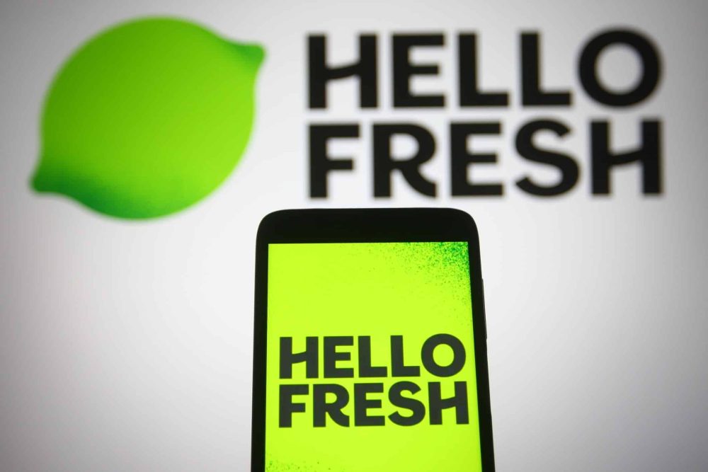 HelloFresh logo on a mobile phone and a computer screen