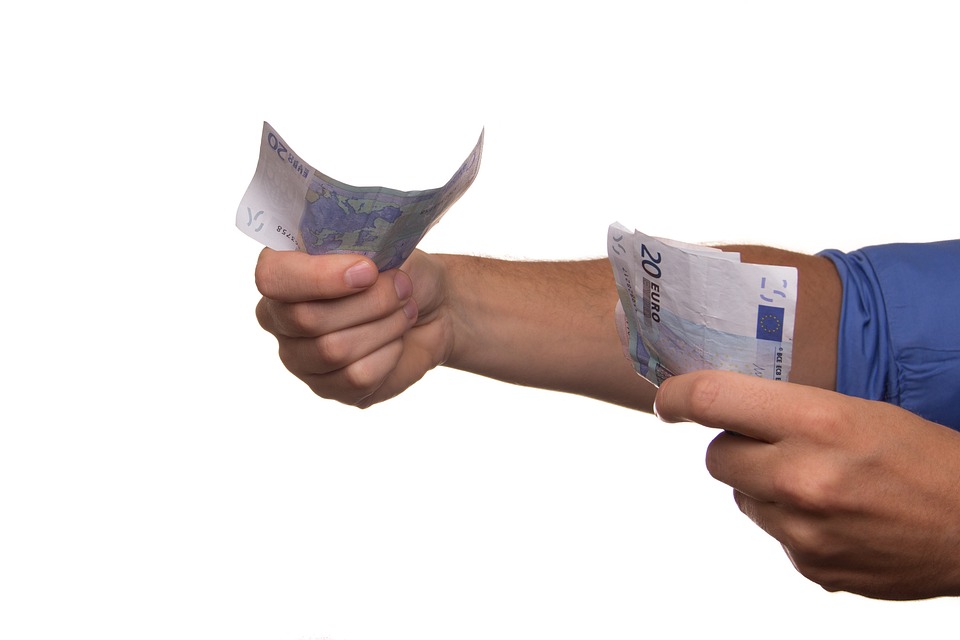 Man holds handfuls of Euros
