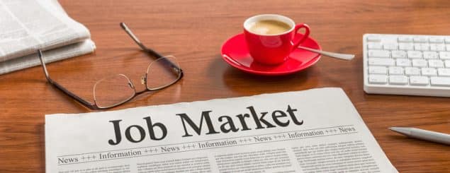 Newspaper with the term job market on it