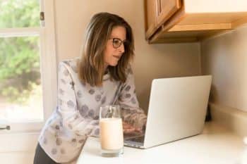 A bereaved woman works on her laptop