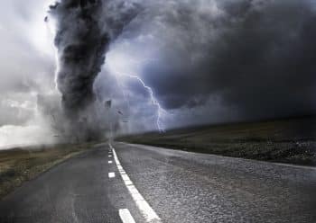 A cyclone whips along a road