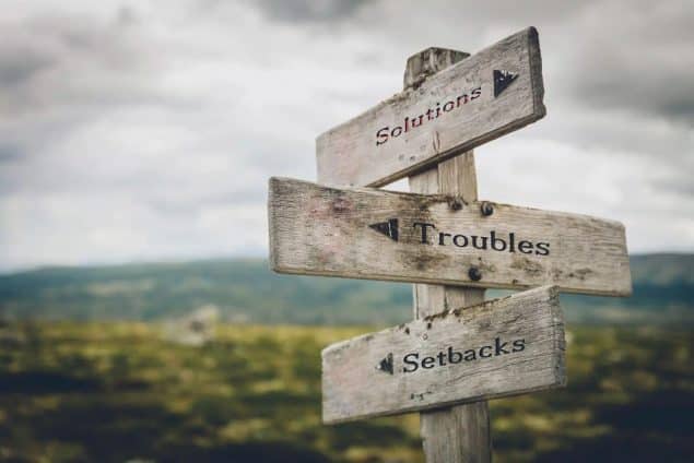 a sign pointing the directions to setbacks troubles and solutions in the opposite way
