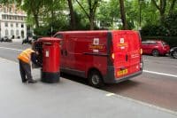 Royal Mail worker collecting the mail from a post box