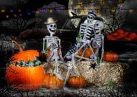 3 spooky skeletons sat on a bench with lots of pumpkins and haloween lights, and a full moon in the back at night with a black sky