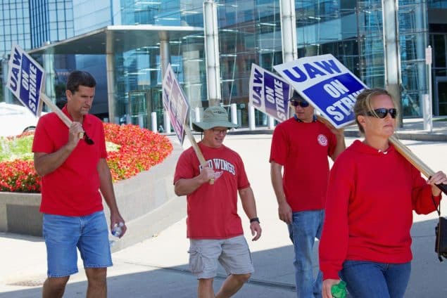 UAW workers striking with signs in front of GM World Headquarters in Downtown Detroit