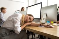A bored worker sleeps at her desk