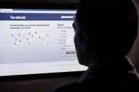 A person looks at Facebook on their PC