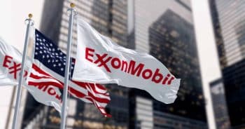 ExxonMobil and the American flags waving in the wind in a financial district