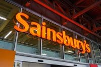 Sainsbury`s supermarket logo sign above the main entrance