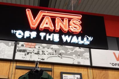 Vans brand logo and text sign front of skate store