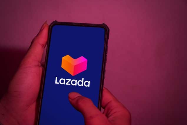 Hands holding phone with lazada logo on the screen
