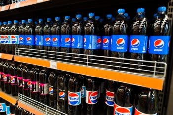 Plastic bottles of Pepsi on supermarket stand shelves