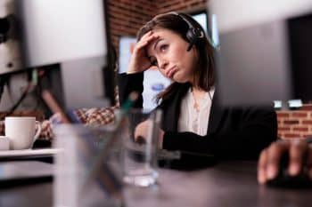 Woman feeling tired and unhappy at customer care support job