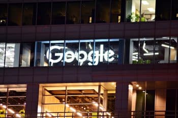 Google sign on company building at night