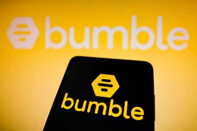 Bumble logo displayed on a smartphone and in the background