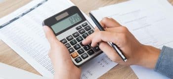 person makes a calculation on a calculator