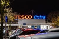 Tesco Extra supermarket logo at night