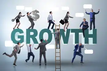 People on a ladder climbing up the word growth