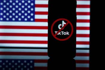 TikTok logo with ban icon in background of USA flag